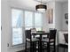 Bright breakfast nook with black accents, a stylish chandelier, and large windows offering a serene view at 6972 Sandtown Ln, Stone Mountain, GA 30087
