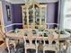 Bright dining room showcasing a large window, decorative hutch, and stylish table setting at 6972 Sandtown Ln, Stone Mountain, GA 30087