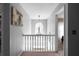 Bright hallway featuring unique lighting fixture, neutral paint, and view to stairwell at 6972 Sandtown Ln, Stone Mountain, GA 30087
