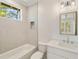 Bathroom featuring a tub, shower, and modern vanity with a window view at 1068 Moores Mill Nw Rd, Atlanta, GA 30327