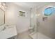 Bathroom featuring a tiled shower, and modern vanity with a backyard view at 1068 Moores Mill Nw Rd, Atlanta, GA 30327