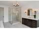 Bathroom featuring a glass shower, vanity with marble countertop and modern lighting at 1068 Moores Mill Nw Rd, Atlanta, GA 30327