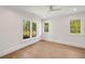Bedroom with hardwood floors and two windows with backyard views at 1068 Moores Mill Nw Rd, Atlanta, GA 30327