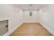 Small bedroom featuring wood floors and a single window with backyard views at 1068 Moores Mill Nw Rd, Atlanta, GA 30327