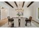 Elegant dining room with a chandelier, wood beams, and a view into other rooms at 1068 Moores Mill Nw Rd, Atlanta, GA 30327