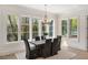 Elegant dining room featuring lots of natural light, a modern table, and hardwood floors at 1068 Moores Mill Nw Rd, Atlanta, GA 30327