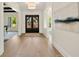 Bright entryway with gleaming hardwood floors, an elegant chandelier, and a view into other rooms at 1068 Moores Mill Nw Rd, Atlanta, GA 30327