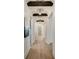 Long hallway with wooden floors, arched entryways and wood beam ceiling details at 1068 Moores Mill Nw Rd, Atlanta, GA 30327