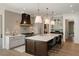 Stylish kitchen with stainless steel appliances, a large island, pendant lights, and hardwood flooring at 1068 Moores Mill Nw Rd, Atlanta, GA 30327