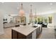 Open-concept kitchen with a large island, pendant lights, and stainless steel appliances adjacent to the dining room at 1068 Moores Mill Nw Rd, Atlanta, GA 30327