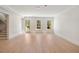 Spacious room with hardwood floors, white trim, natural light, and staircase access at 1068 Moores Mill Nw Rd, Atlanta, GA 30327