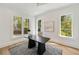 Bright home office with large windows, sleek black desk and neutral decor at 1068 Moores Mill Nw Rd, Atlanta, GA 30327