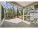 Spacious covered patio area overlooking landscaped backyard with wrought iron railing at 1068 Moores Mill Nw Rd, Atlanta, GA 30327