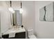 Modern powder room featuring stylish lighting, vanity, mirror, and a sleek toilet at 1068 Moores Mill Nw Rd, Atlanta, GA 30327