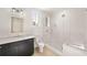 Well-lit bathroom with modern fixtures, featuring a glass shower, vanity with marble countertop, and stylish mirror at 1074 Moores Mill Nw Rd, Atlanta, GA 30327
