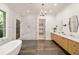 A luxurious bathroom with a standalone tub, walk-in shower, and double vanity at 1074 Moores Mill Nw Rd, Atlanta, GA 30327