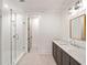Sleek bathroom featuring a glass shower, dark wood vanity with marble countertop, and modern lighting fixtures at 1074 Moores Mill Nw Rd, Atlanta, GA 30327