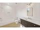 Stylish bathroom featuring a shower-tub combo, dark wood vanity with marble countertop, and a large mirror at 1074 Moores Mill Nw Rd, Atlanta, GA 30327