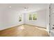 Sunny bedroom showcasing hardwood floors, white trim, and large windows providing natural light and pleasant views at 1074 Moores Mill Nw Rd, Atlanta, GA 30327