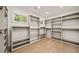 A large walk-in closet with custom built-in shelving and natural light at 1074 Moores Mill Nw Rd, Atlanta, GA 30327