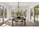 Dining area filled with natural light, open view to outside, and modern chandelier at 1074 Moores Mill Nw Rd, Atlanta, GA 30327
