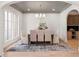 Elegant dining room boasts large windows, neutral decor, a modern chandelier, and hardwood floors at 1074 Moores Mill Nw Rd, Atlanta, GA 30327
