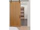 Interior shot of wooden sliding door leading to a closet with custom shelving at 1074 Moores Mill Nw Rd, Atlanta, GA 30327