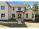 Beautiful two-story painted brick home with a well-manicured lawn, stone walkway, and mature trees at 1074 Moores Mill Nw Rd, Atlanta, GA 30327