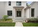 Close-up of front entrance featuring elegant black metal door, overhead light, and concrete walkway at 1074 Moores Mill Nw Rd, Atlanta, GA 30327