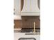 Close-up of kitchen with tiled backsplash and professional gas range at 1074 Moores Mill Nw Rd, Atlanta, GA 30327