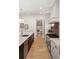 Custom kitchen with stainless steel appliances and view of hallway with custom bench at 1074 Moores Mill Nw Rd, Atlanta, GA 30327