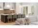 The home has an open-concept kitchen with a large island and bar seating at 1074 Moores Mill Nw Rd, Atlanta, GA 30327