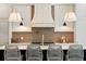 Contemporary kitchen features a custom range hood and tiled backsplash at 1074 Moores Mill Nw Rd, Atlanta, GA 30327