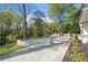 Inviting pool area surrounded by stone patio and lush landscaping, creating a serene outdoor oasis for relaxation and enjoyment at 1074 Moores Mill Nw Rd, Atlanta, GA 30327