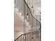 Modern staircase with black metal railing and decorative pendant lighting at 1074 Moores Mill Nw Rd, Atlanta, GA 30327