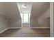 Cozy attic space featuring unique architecture, window, and neutral colored walls at 1124 Lawton Sw Pl, Atlanta, GA 30310