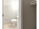 Small bathroom with tiled flooring, a toilet, and a sink at 1124 Lawton Sw Pl, Atlanta, GA 30310