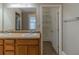 Bathroom featuring a double sink vanity, a large mirror and a walk-in closet with shelving at 1124 Lawton Sw Pl, Atlanta, GA 30310