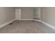 Bedroom with neutral walls and carpet, featuring baseboard trim and a large mirror at 1124 Lawton Sw Pl, Atlanta, GA 30310