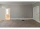 Bedroom with neutral walls, carpet, trim, and a door leading to a bathroom with garden tub at 1124 Lawton Sw Pl, Atlanta, GA 30310