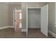 Bedroom with neutral walls and carpet, featuring an open closet and baseboard trim at 1124 Lawton Sw Pl, Atlanta, GA 30310