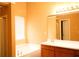 Well-lit bathroom features a tub, shower, and a spacious vanity area at 1972 Ashwood Grove Dr, Snellville, GA 30078