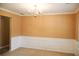 Charming dining area features a chandelier, neutral walls and traditional wainscotting at 1972 Ashwood Grove Dr, Snellville, GA 30078