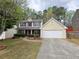 Inviting two-story home with a two car garage and manicured landscaping at 1972 Ashwood Grove Dr, Snellville, GA 30078