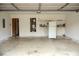 Clean garage interior with white walls, shelving, water heater, and a refrigerator at 1972 Ashwood Grove Dr, Snellville, GA 30078