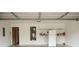 Clean garage interior with white walls, shelving, water heater, and a refrigerator at 1972 Ashwood Grove Dr, Snellville, GA 30078