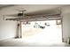 Spacious garage with open door, ladder, and view of cars outside at 1972 Ashwood Grove Dr, Snellville, GA 30078