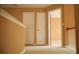 Hallway with neutral carpet and white doors leading to various rooms at 1972 Ashwood Grove Dr, Snellville, GA 30078