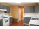 Bright kitchen showcasing grey cabinets, white countertops, and an oven range, with a glimpse into the adjacent living space at 1972 Ashwood Grove Dr, Snellville, GA 30078