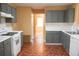 Kitchen featuring grey cabinets, white countertops, and hardwood floors with appliances including a range, oven, and dishwasher at 1972 Ashwood Grove Dr, Snellville, GA 30078